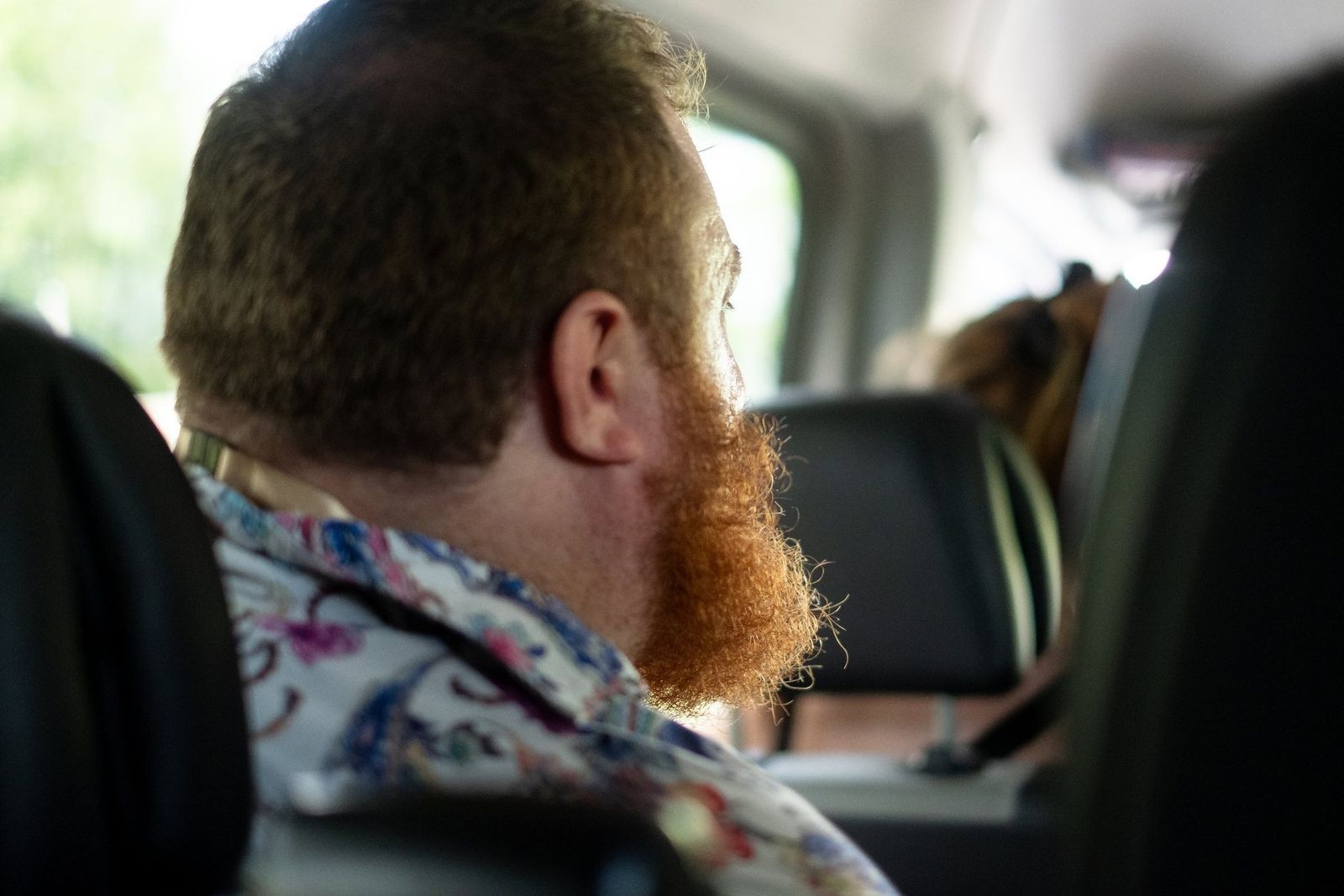 A band member looking out of the van window on the way to the festival