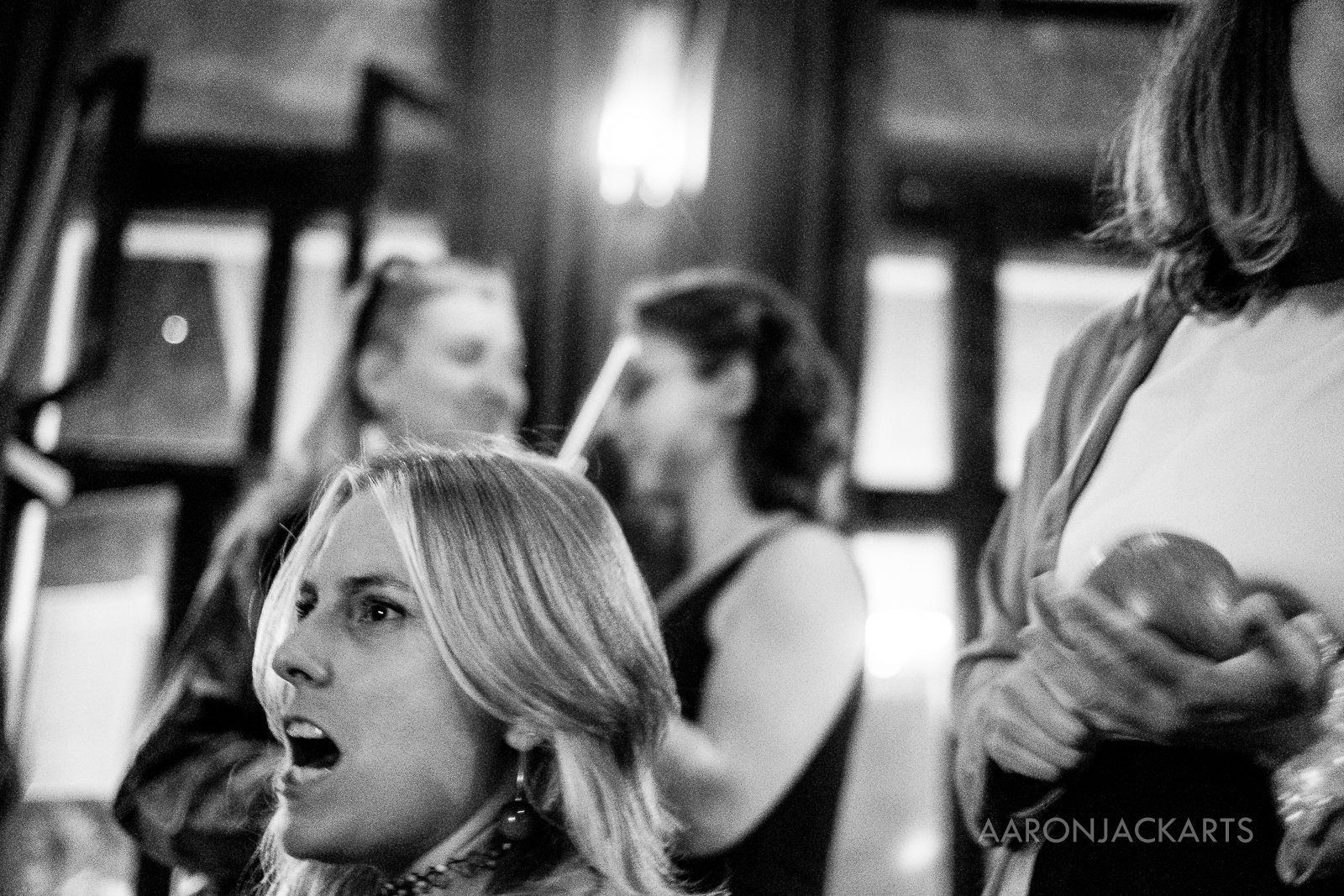 A crowd in a bar, black and white