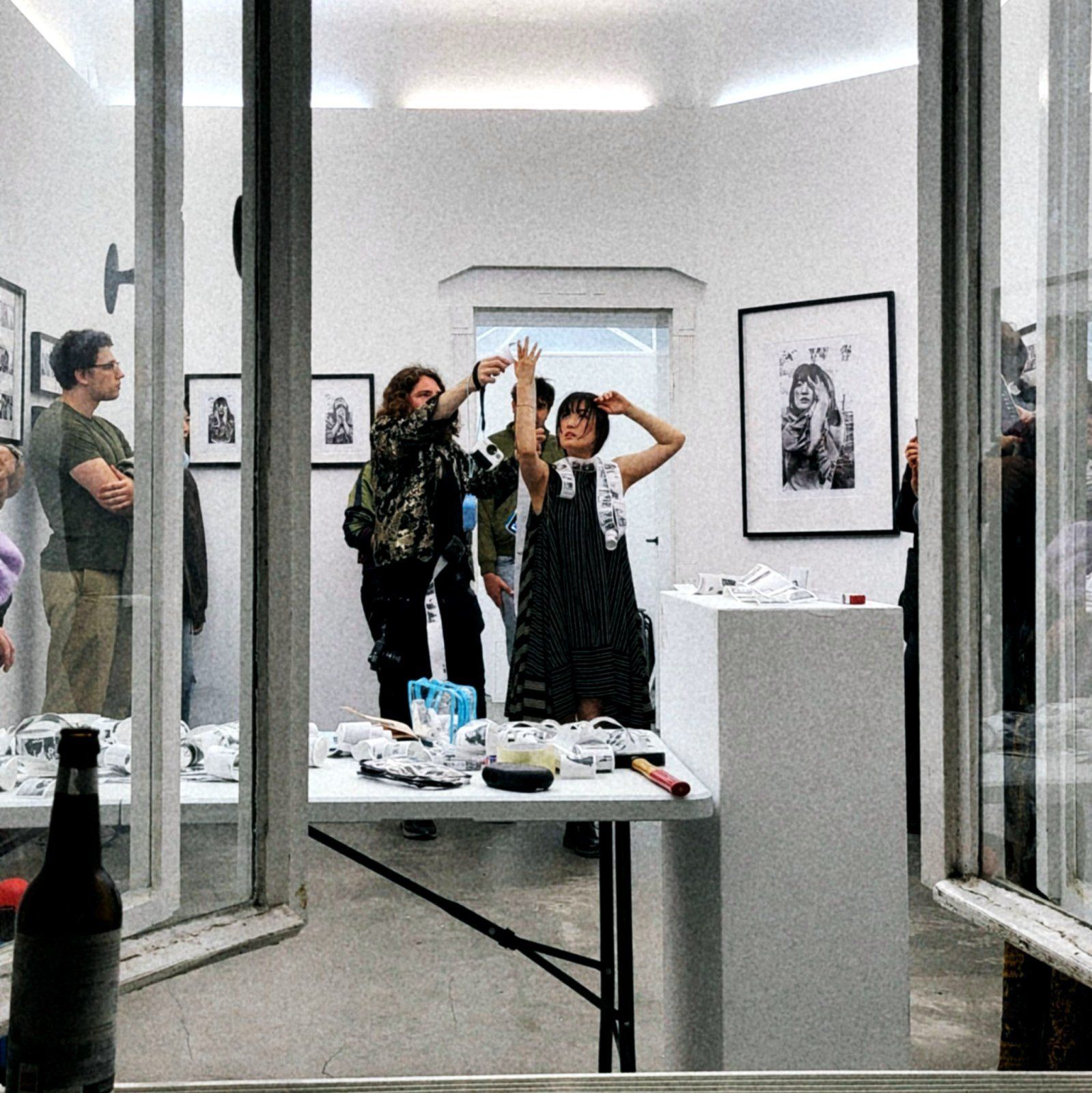 A dancer moving through the window frame with the crowd behind