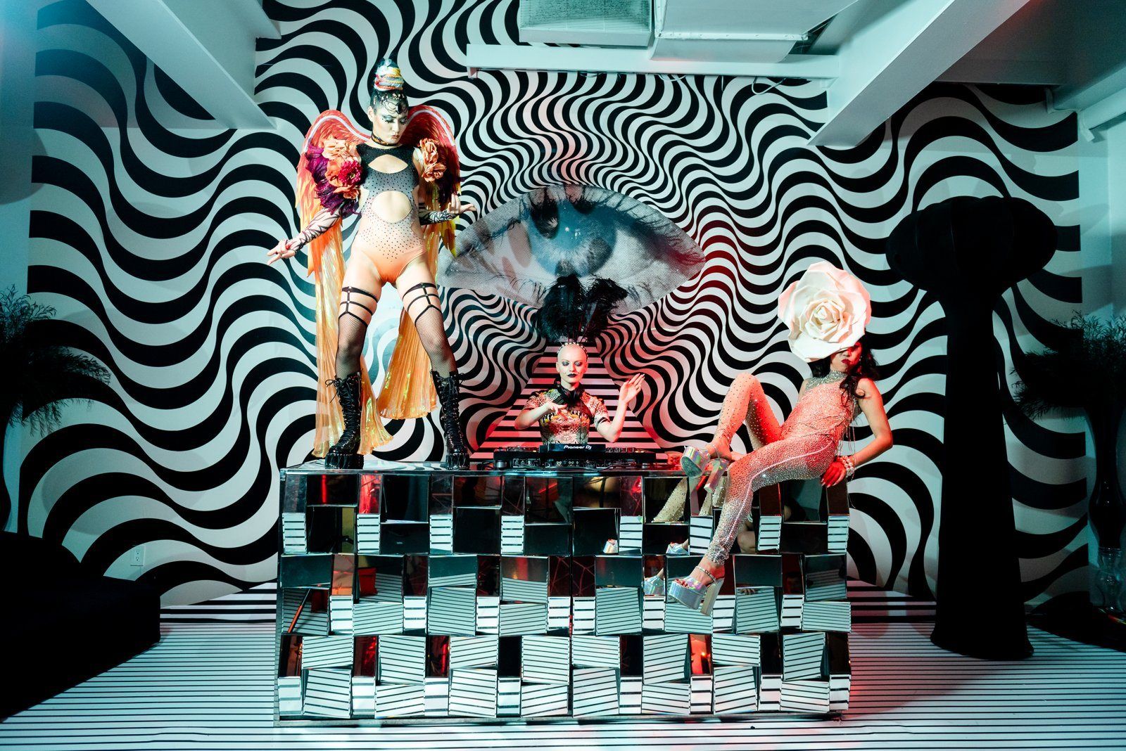 A DJ booth in a black and white swirl room