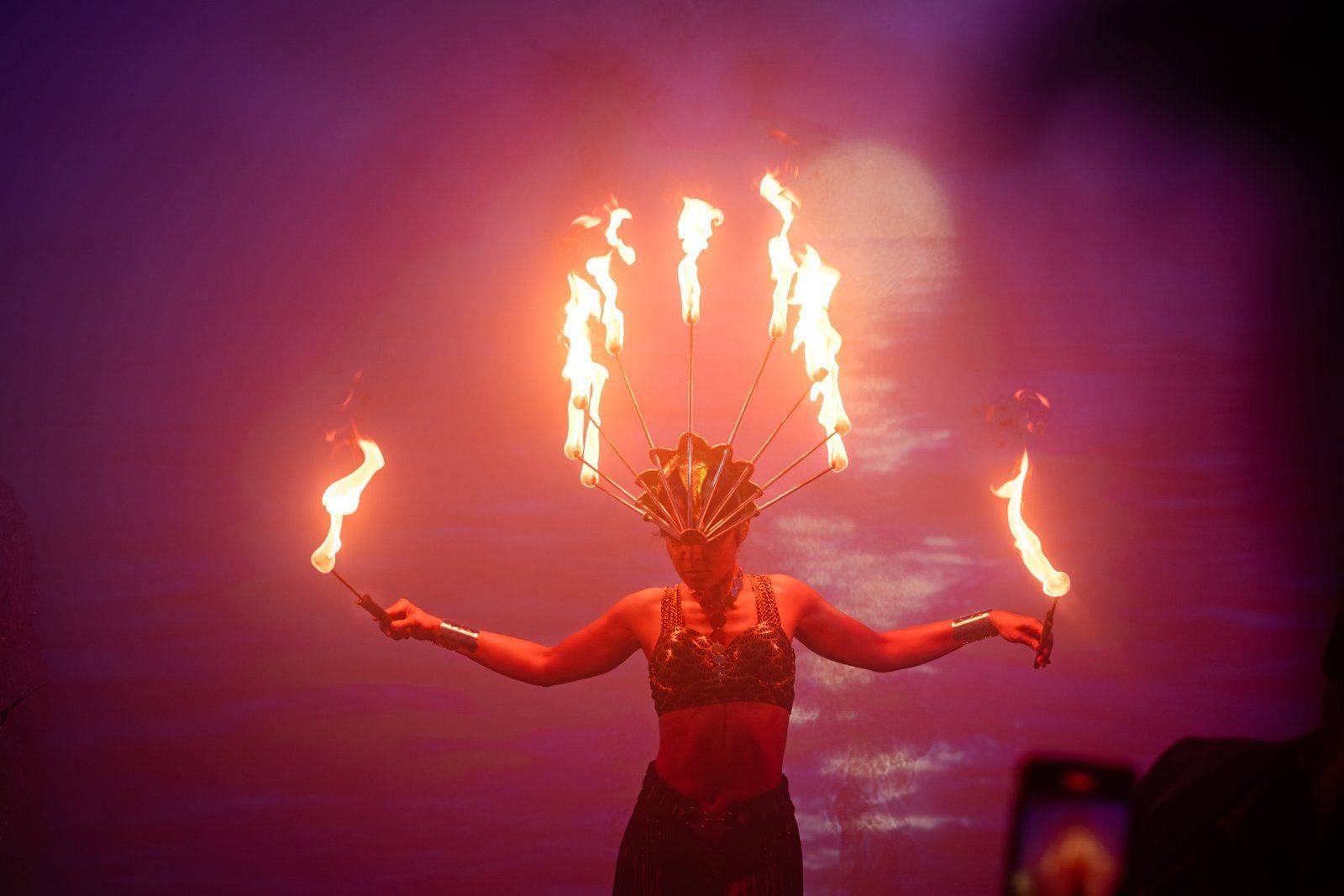 A fire dancer in purple light