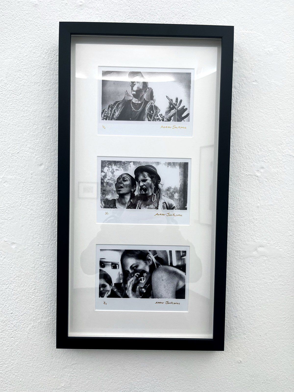 A framed strip of three portraits