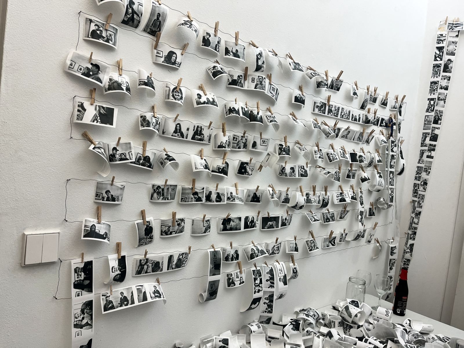 A gallery wall covered in hundreds of small thermal portrait prints