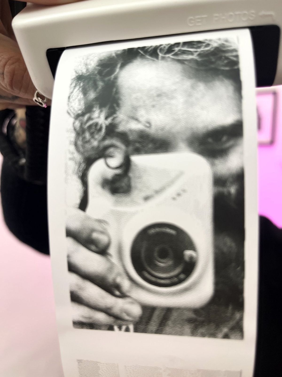 A guest holding the camera with her portrait coming out