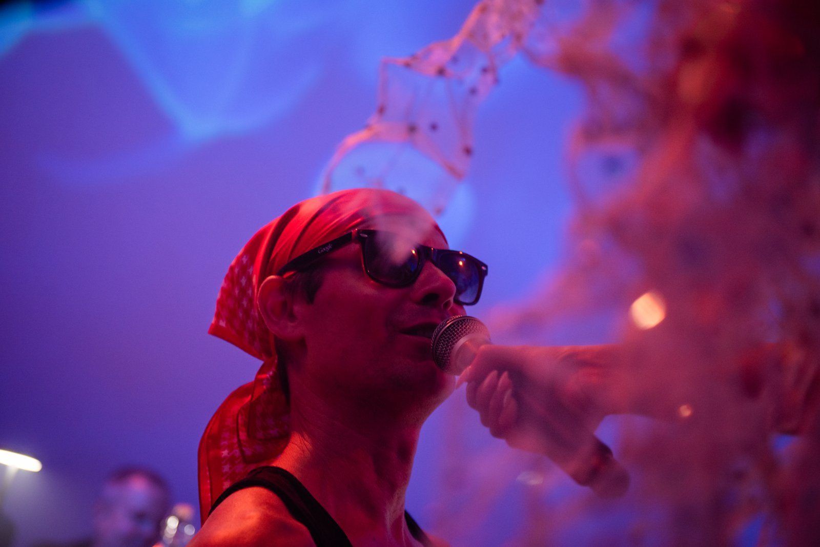 A guest in red light and smoke