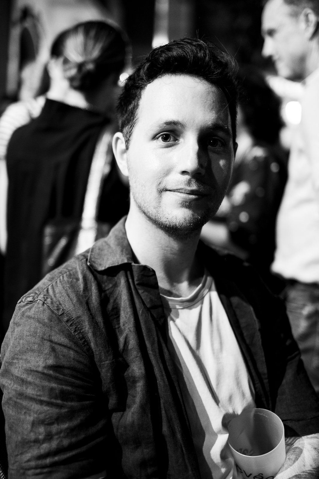 A man in a denim shirt in a crowd