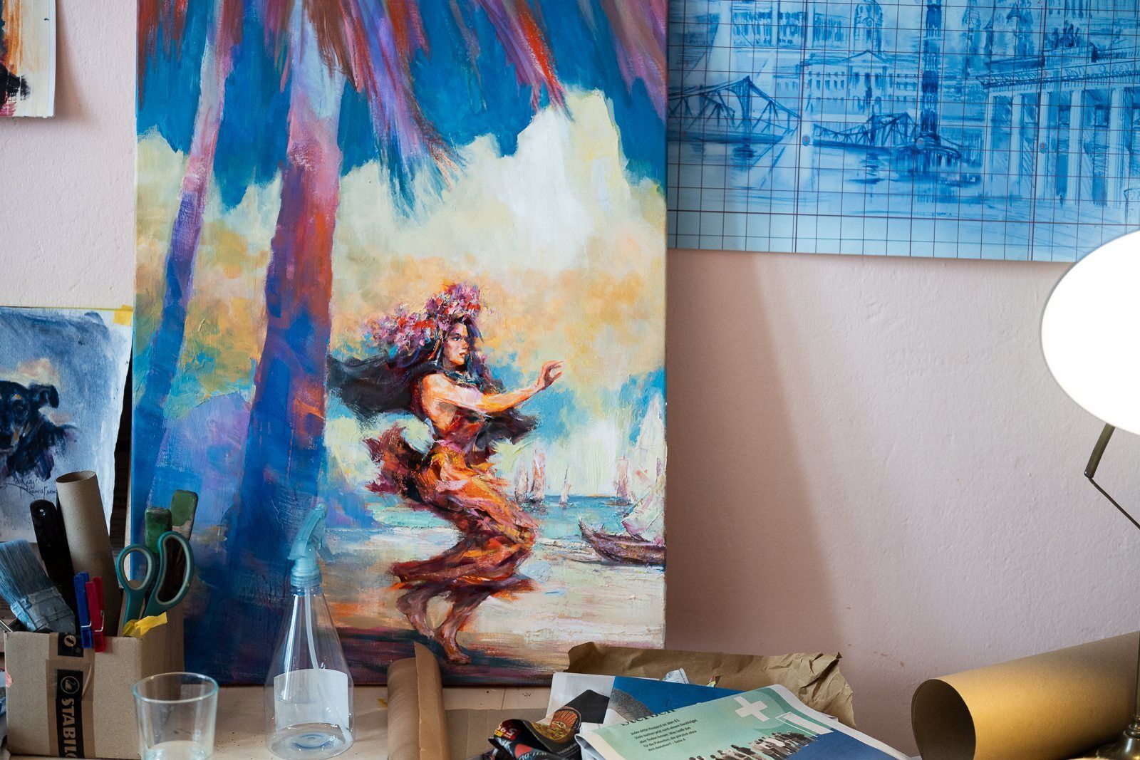 A painting of a dancer under palms on the studio wall