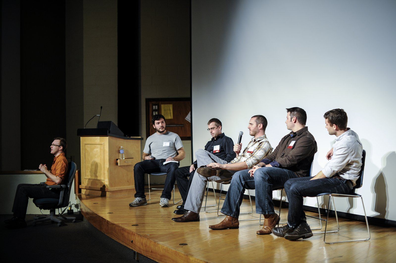 A panel of speakers on stage