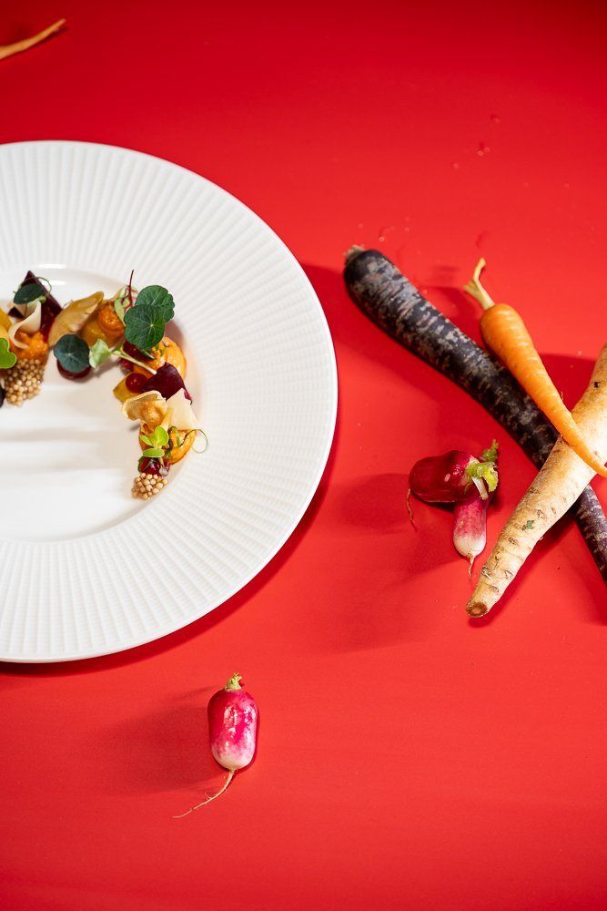 A plate on red with carrots