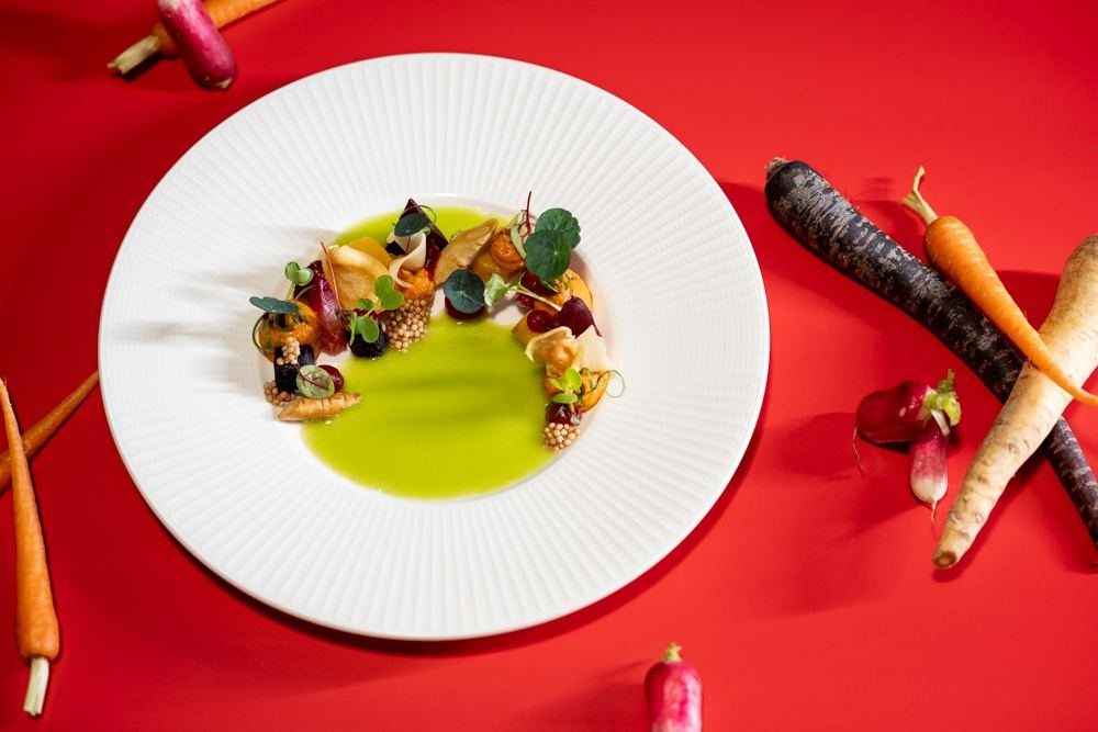 A plated dish on a red table