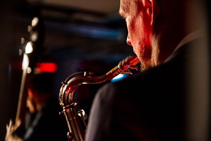 A saxophonist in red light
