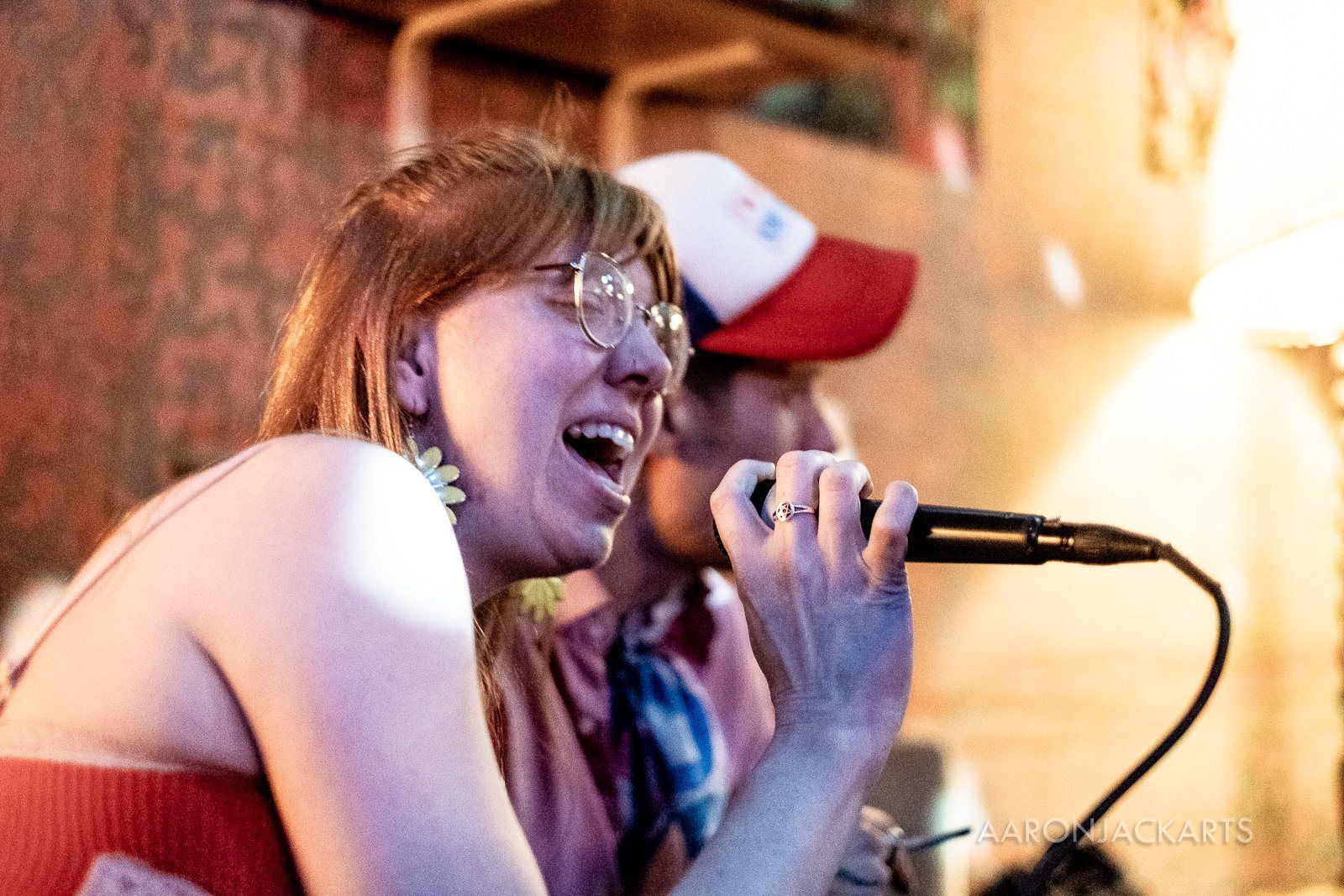 A singer at the mic, laughing
