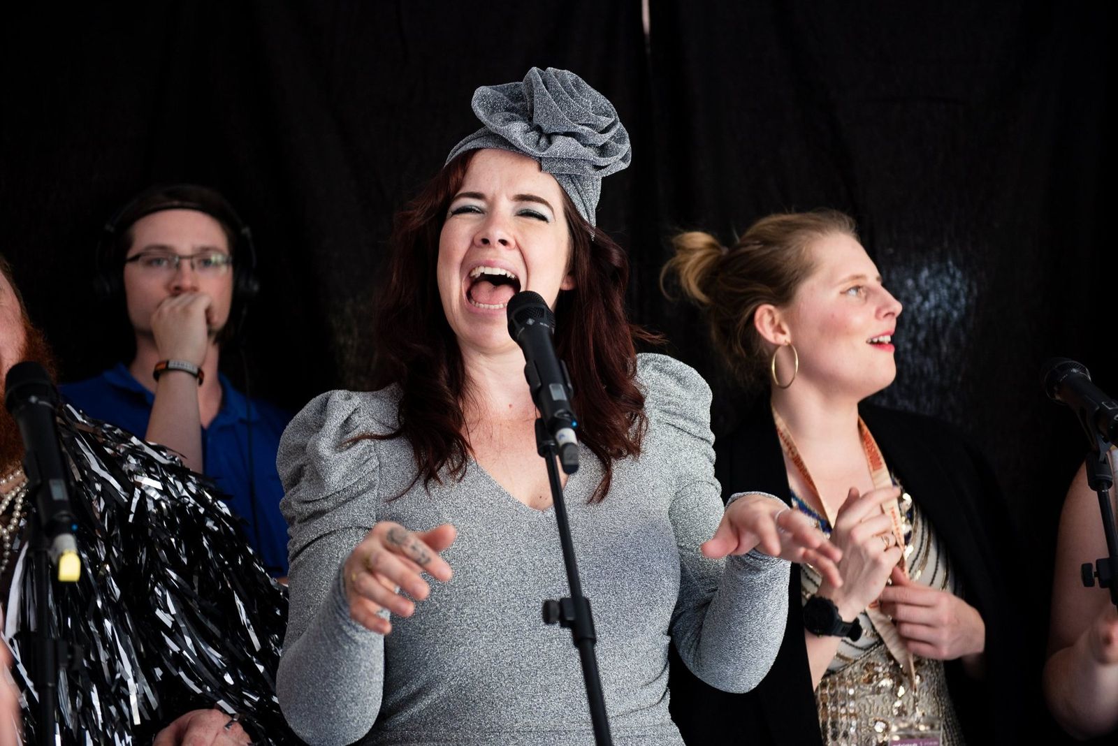 A singer laughing into the microphone during the radio session