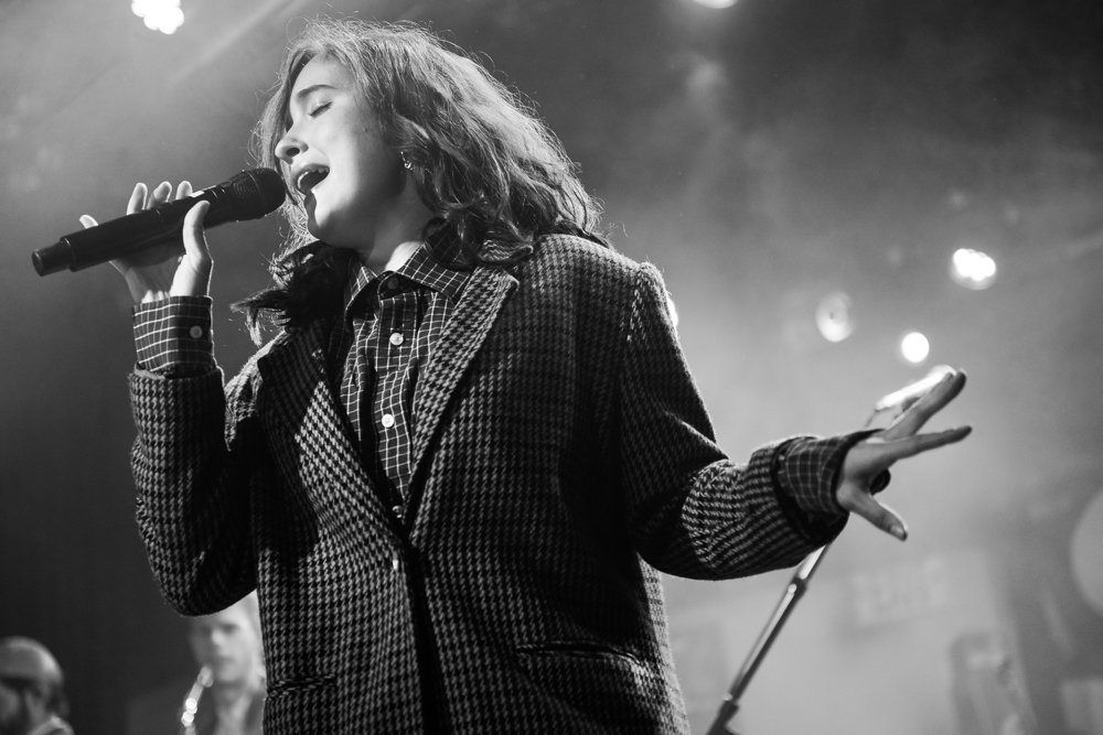 A singer reaching out from the stage