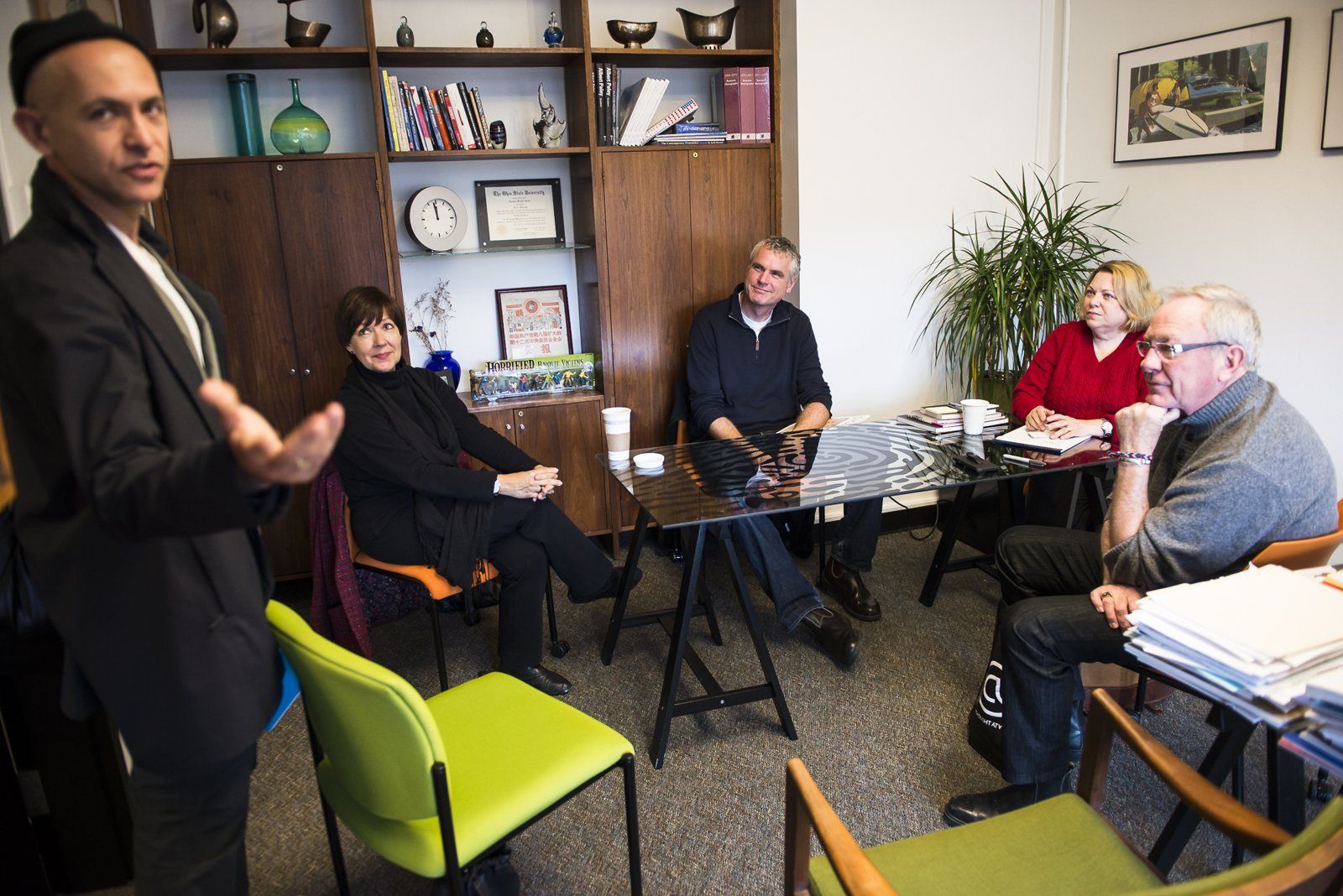 A speaker talking to a small group in an office