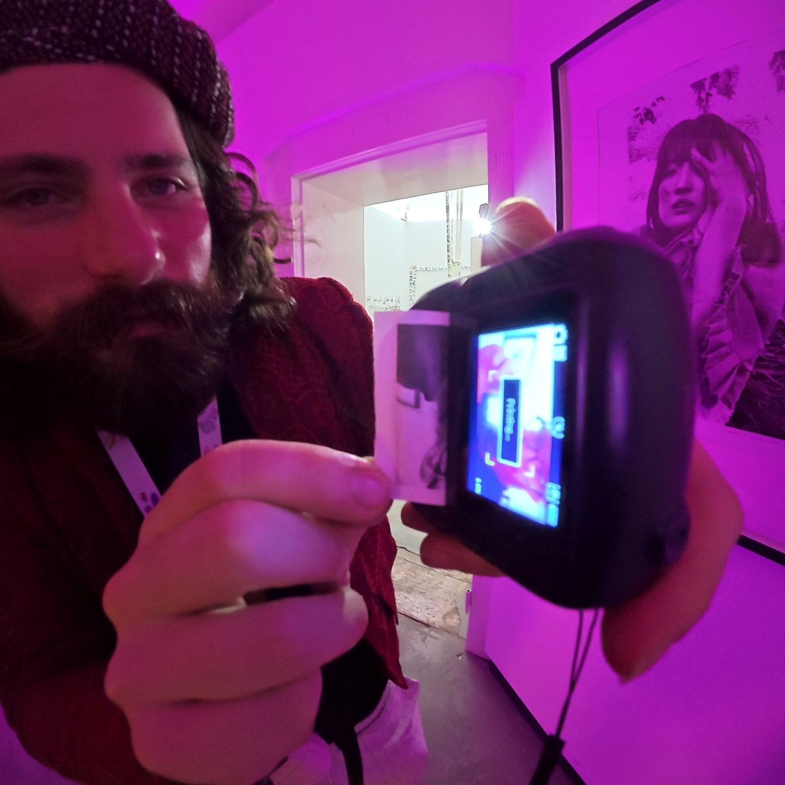 A thermal print coming out of the camera, held up to the lens
