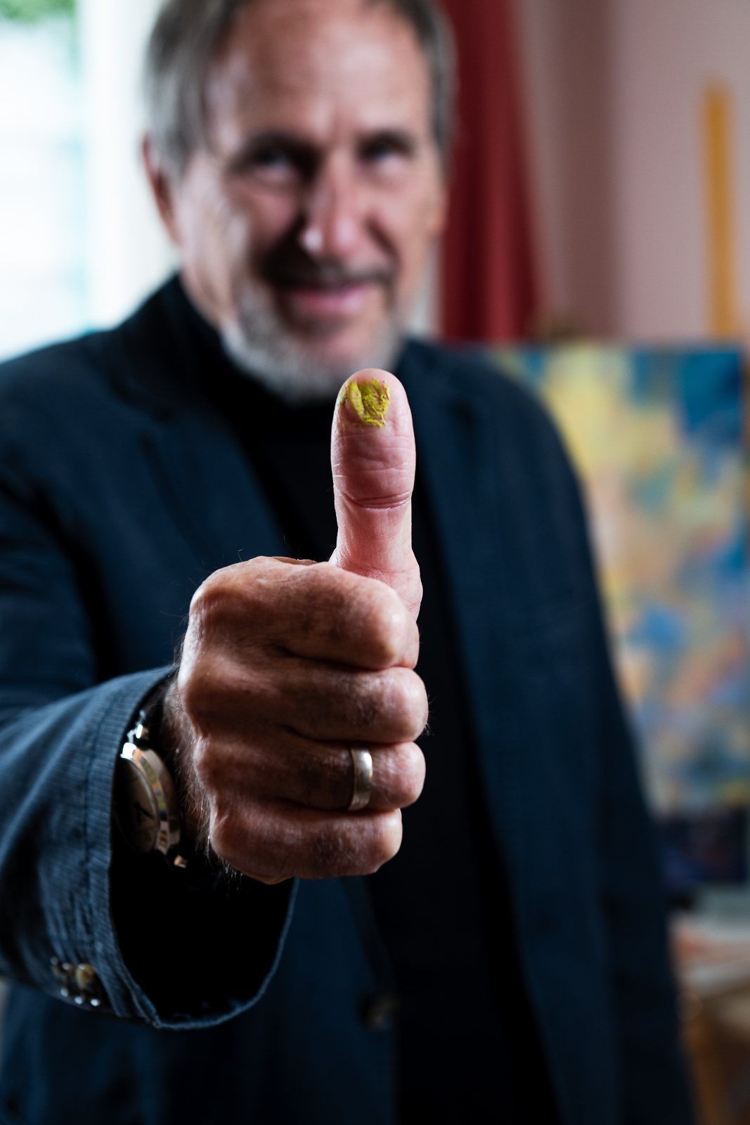 A thumbs up with paint on the thumb