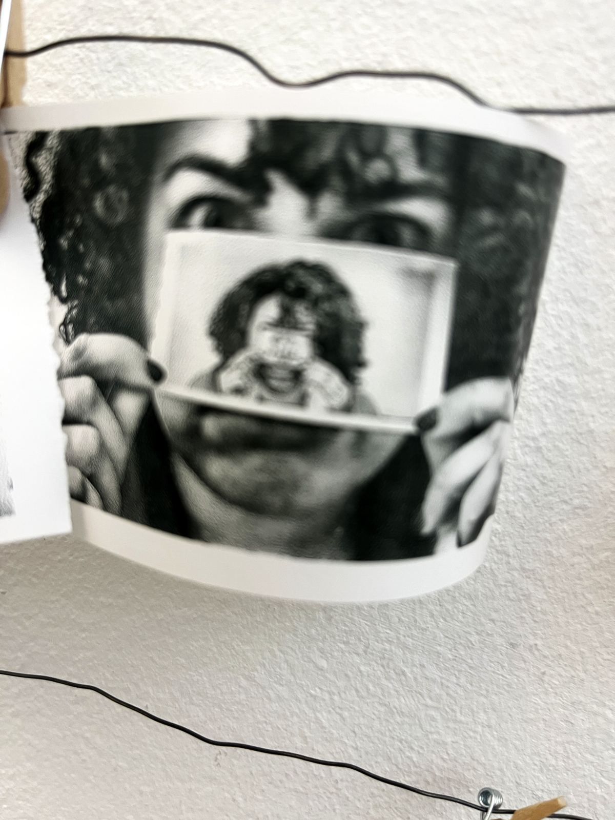 A visitor holding the thermal print of their own face