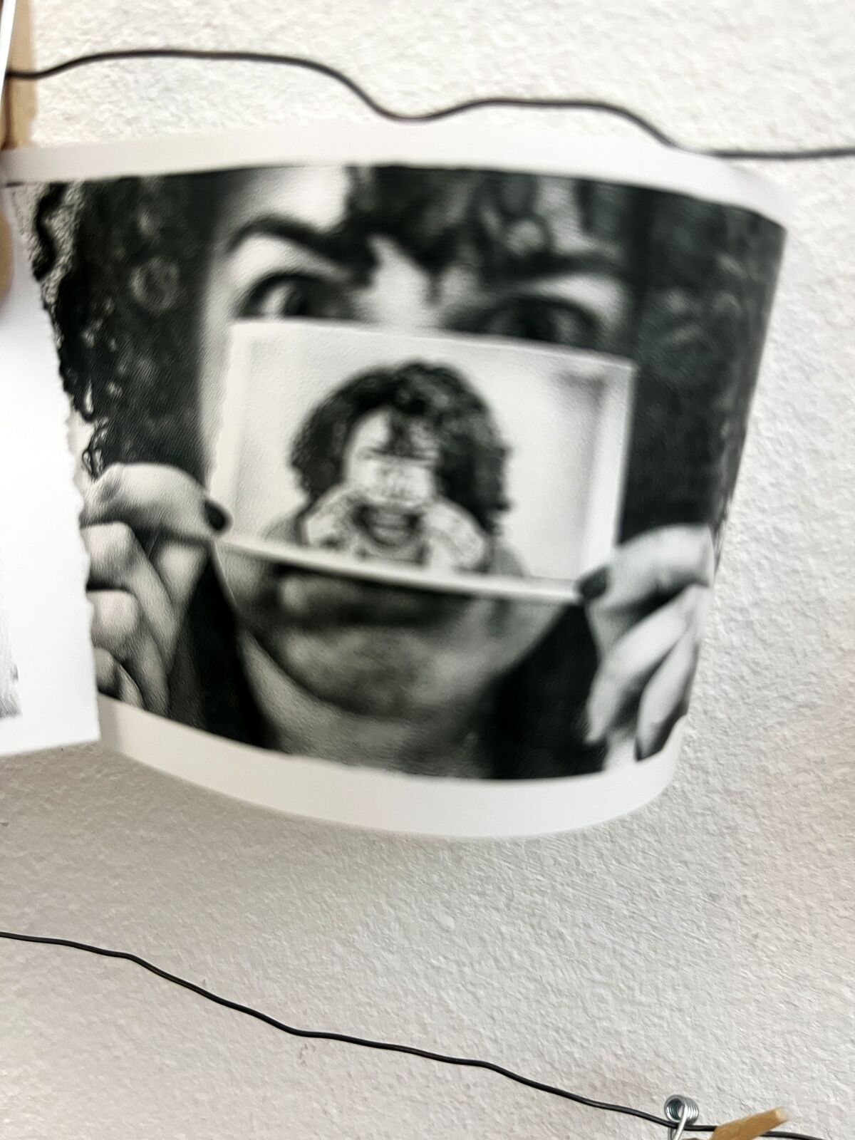 A visitor holding their own thermal portrait over their face