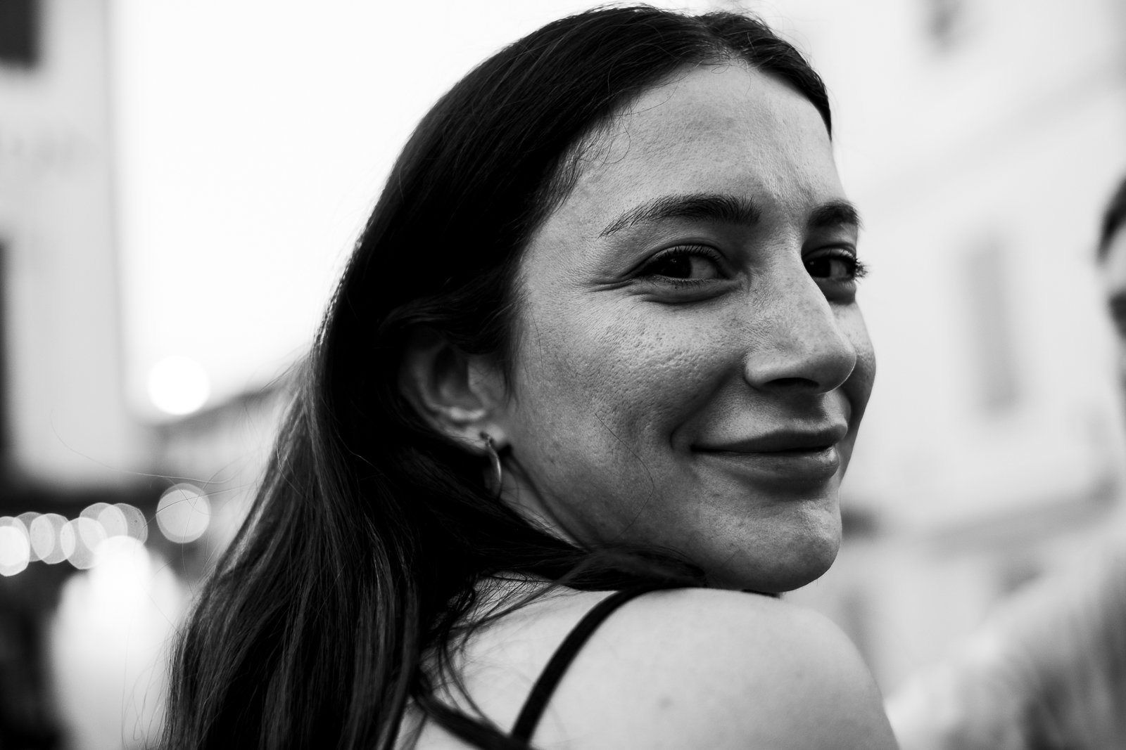 A woman looking back over her shoulder, black and white