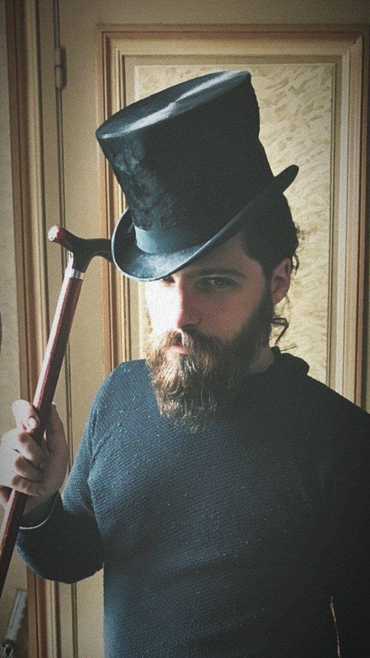 Aaron in a top hat with a cane