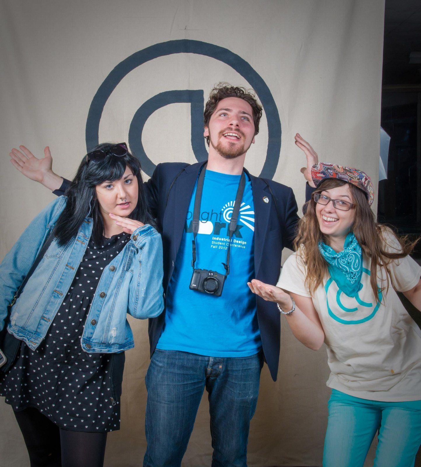 Aaron Jack in a Thought at Work T-shirt with two students in front of the @ logo