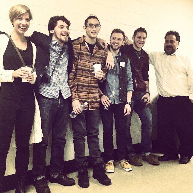 Aaron Jack laughing with the organisers and a professor