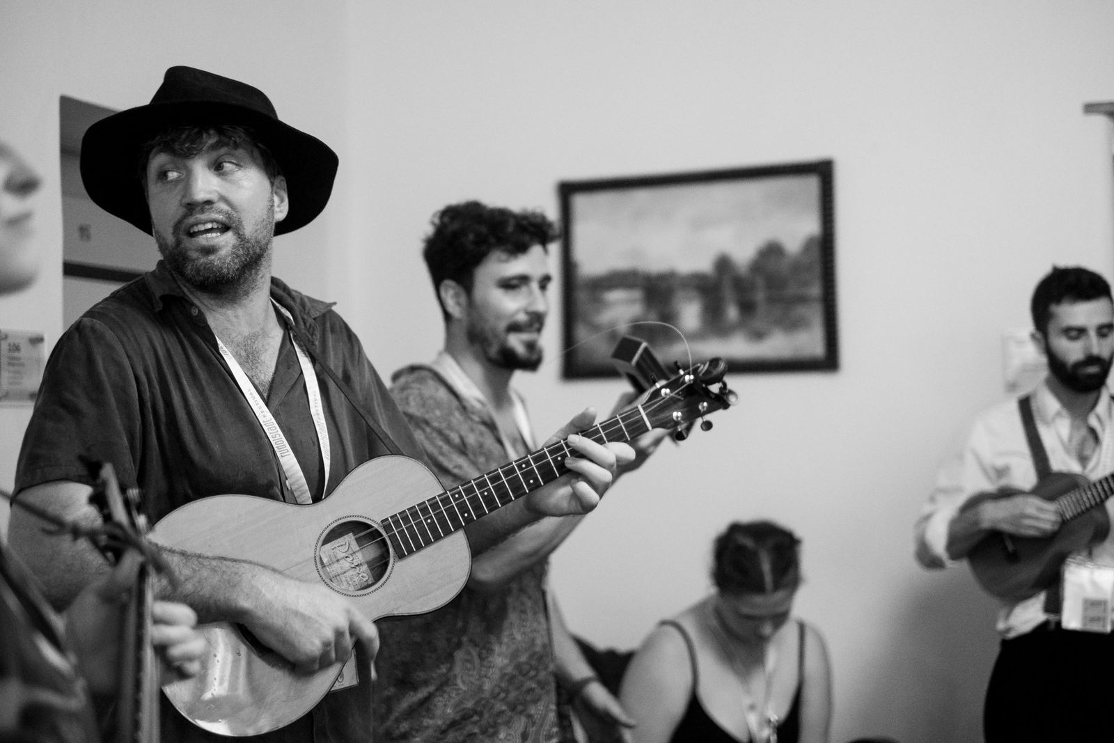 Band members playing ukuleles for the people sheltering from the storm, black and white