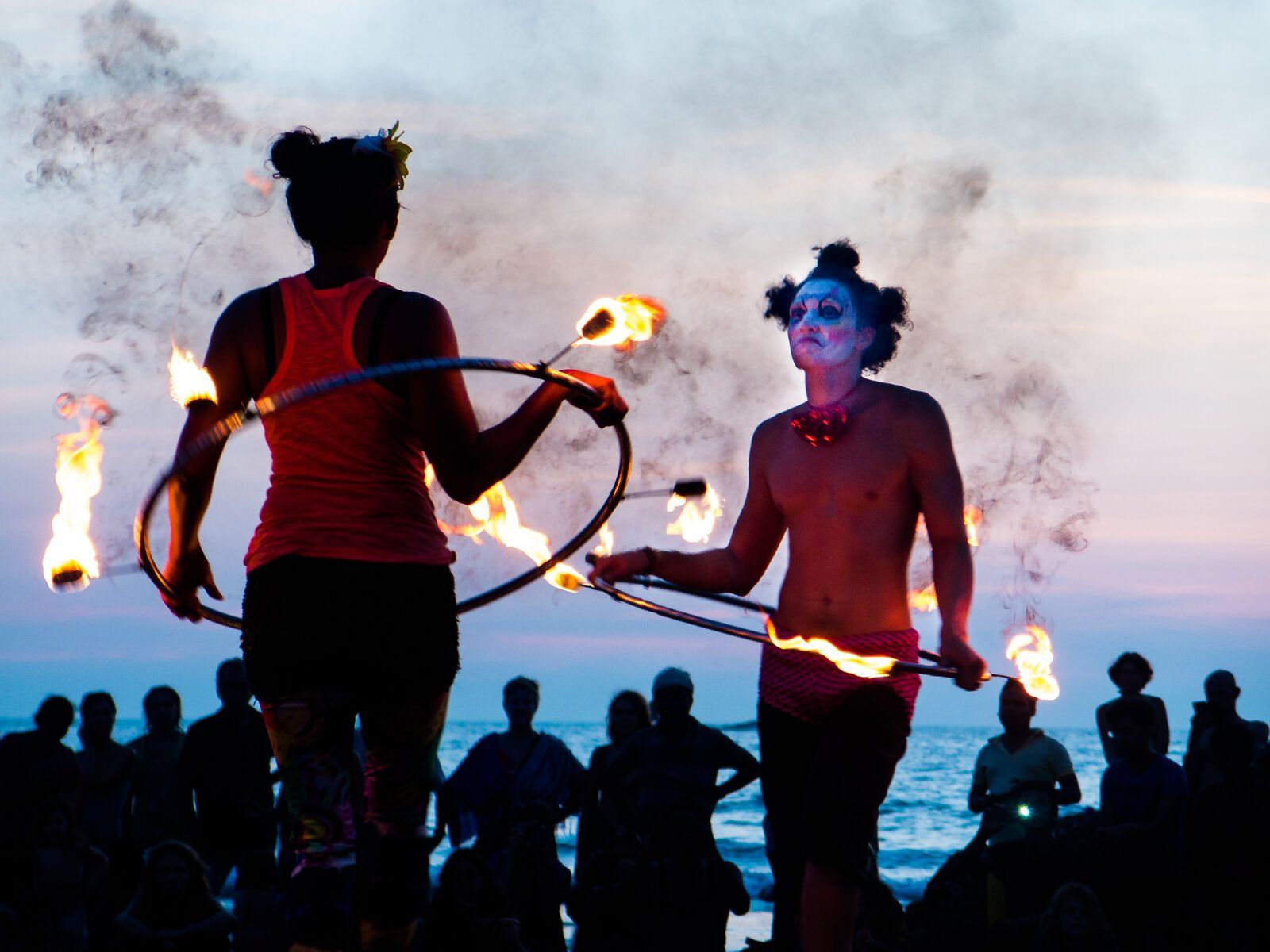 Fire dancers at dusk on the beach