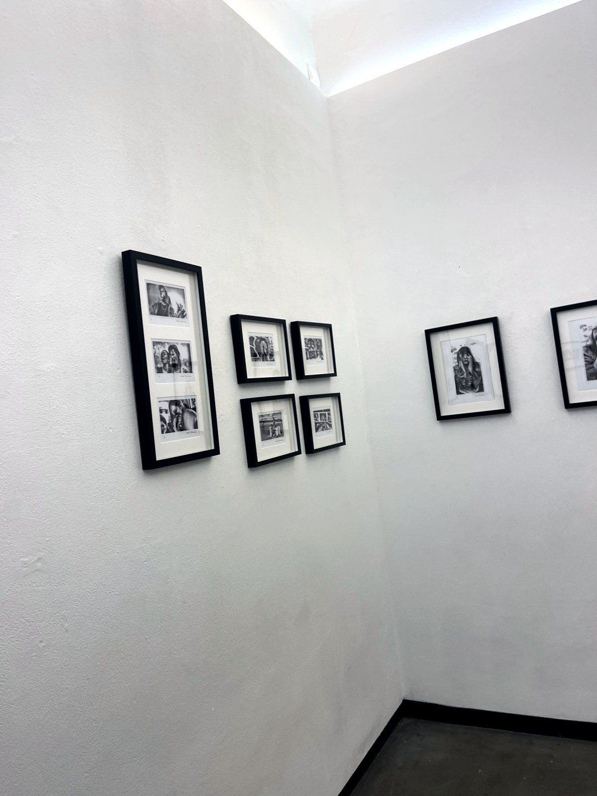 Framed portraits on the gallery wall