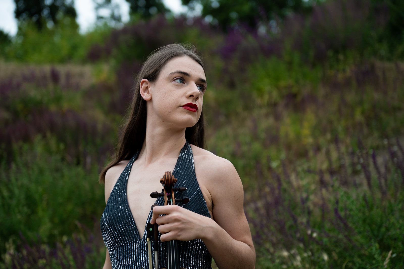 Julia in a sequinned dress, violin at her side