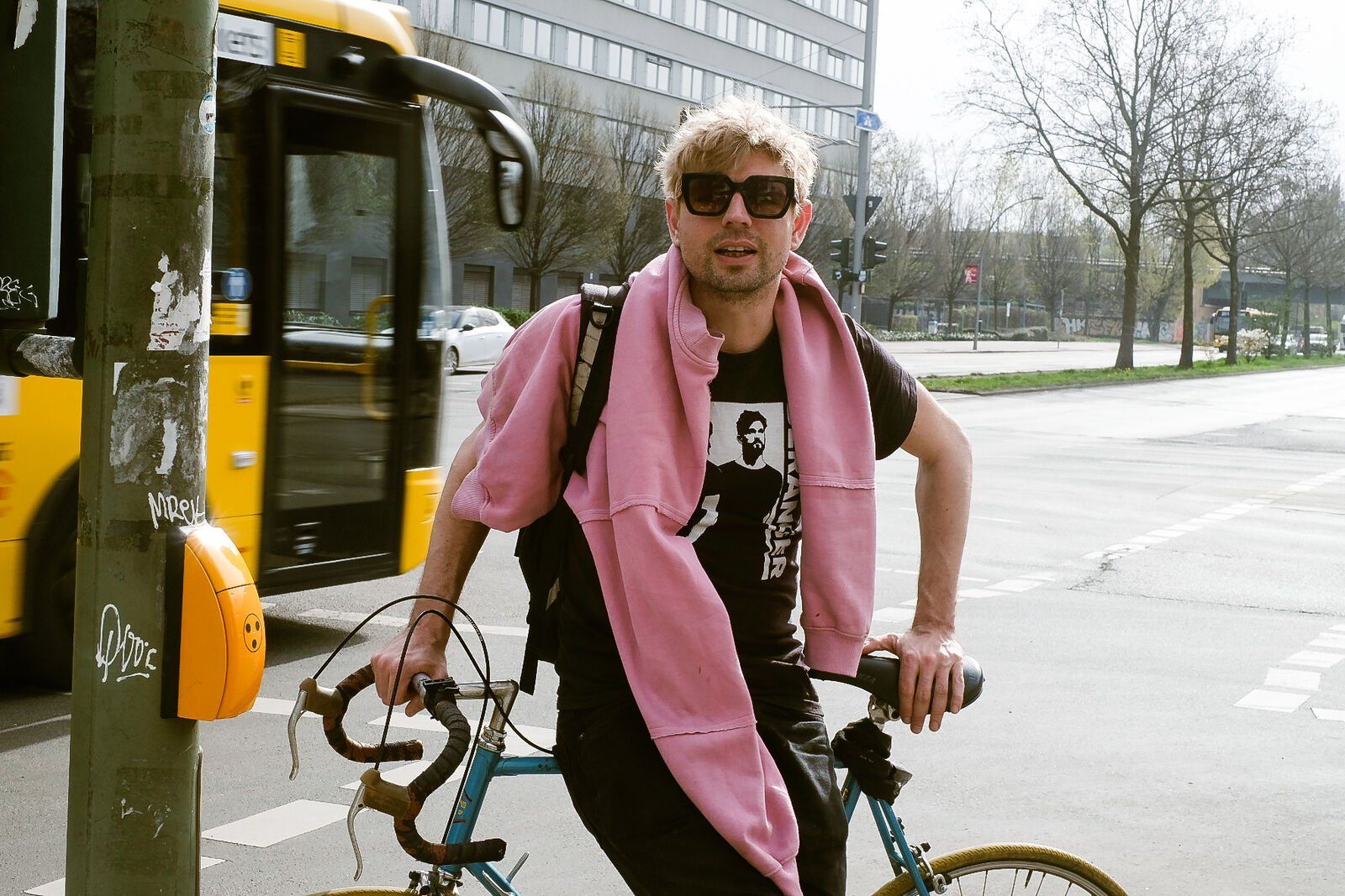 Mikey on his bike in a pink scarf