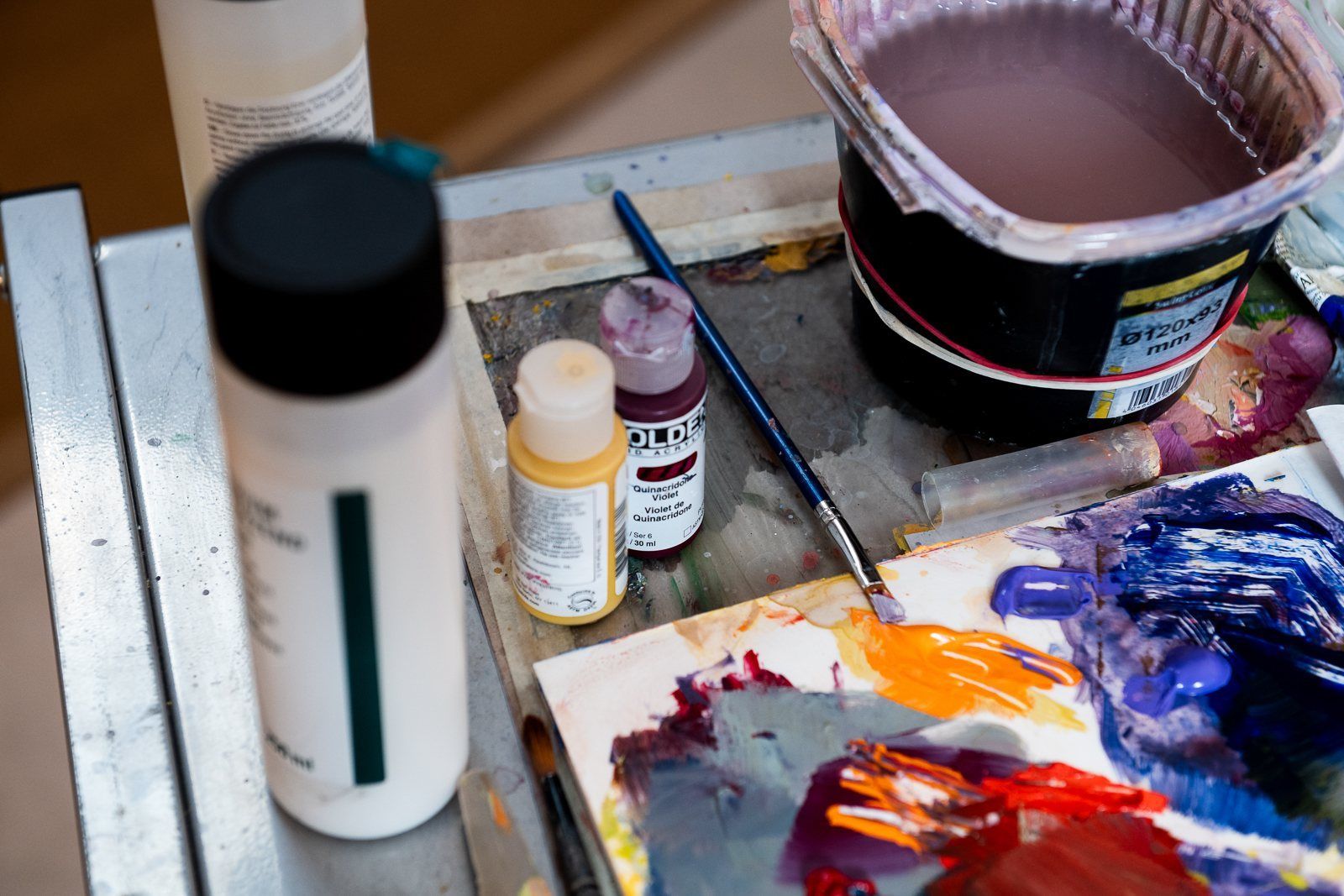Paint, brushes and a loaded palette on Rod Cameron’s work table