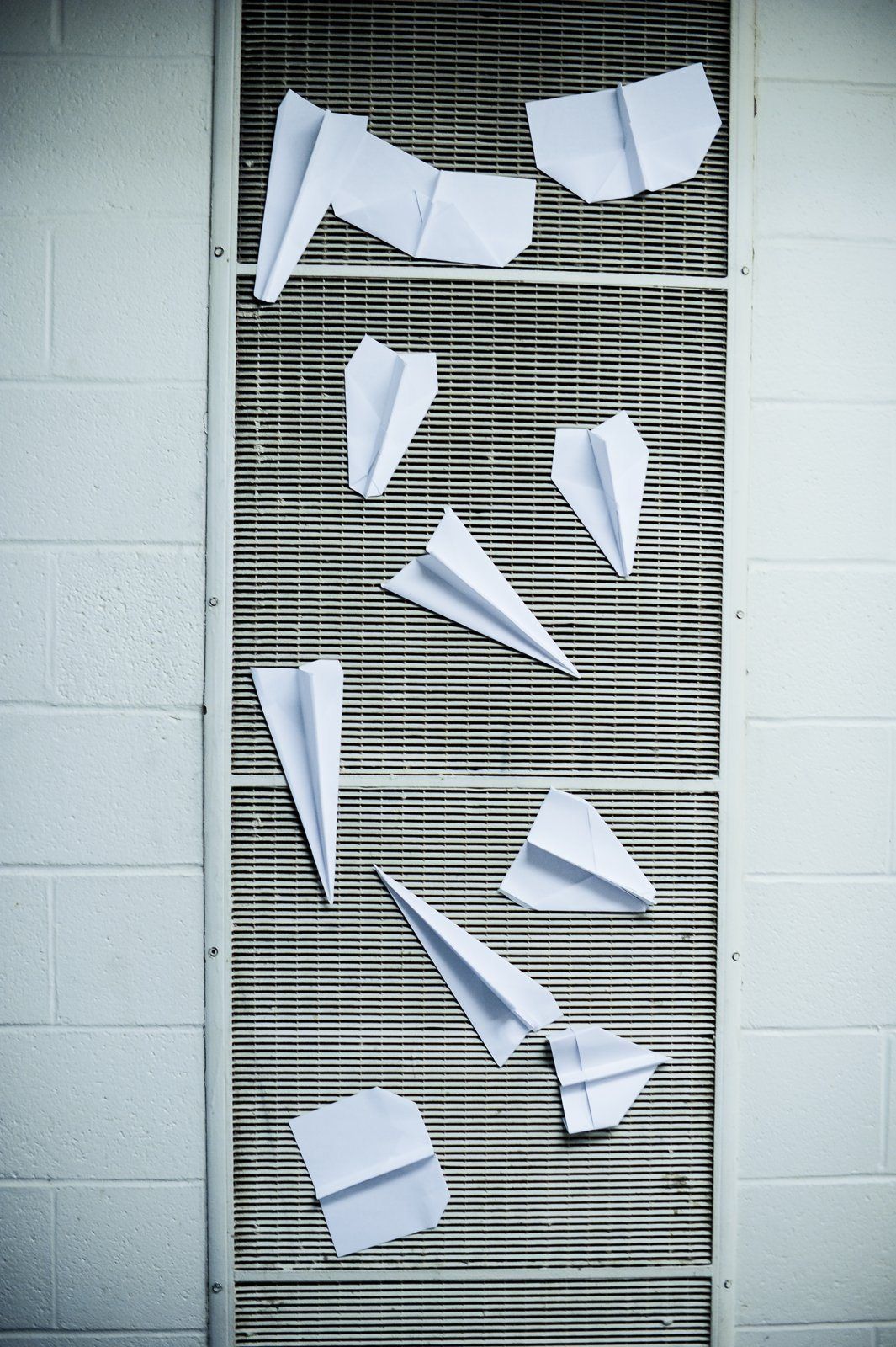 Paper airplanes pinned to a wall