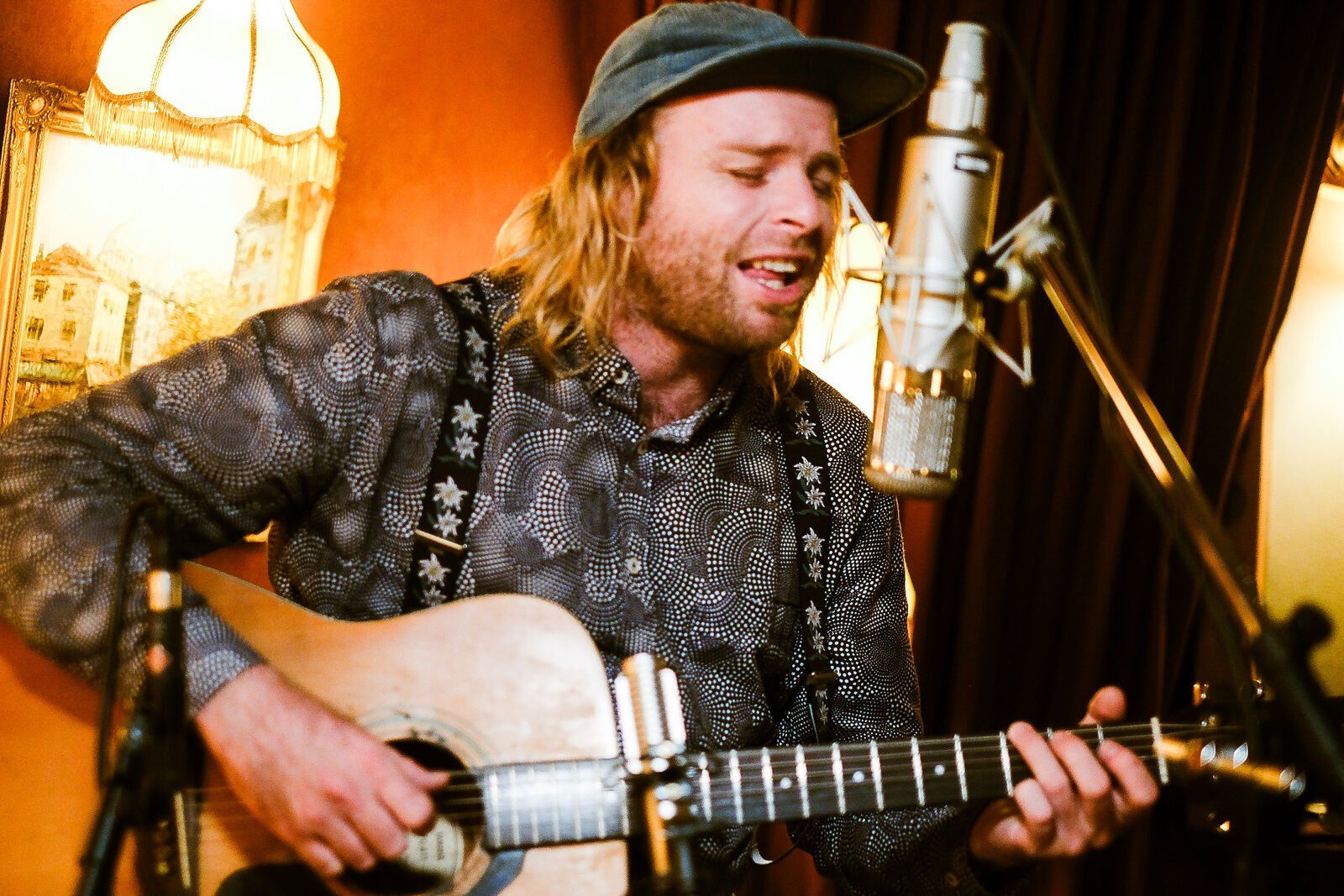 Reuben Stone singing with an acoustic guitar