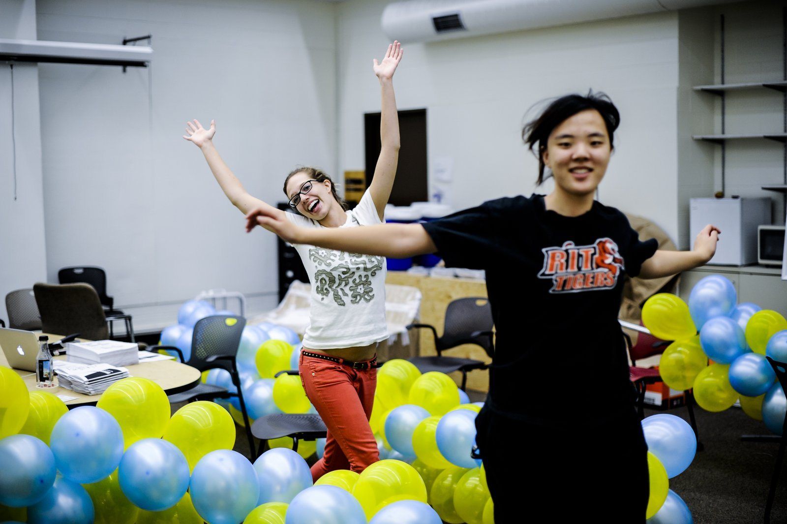 Students celebrating among yellow and blue balloons