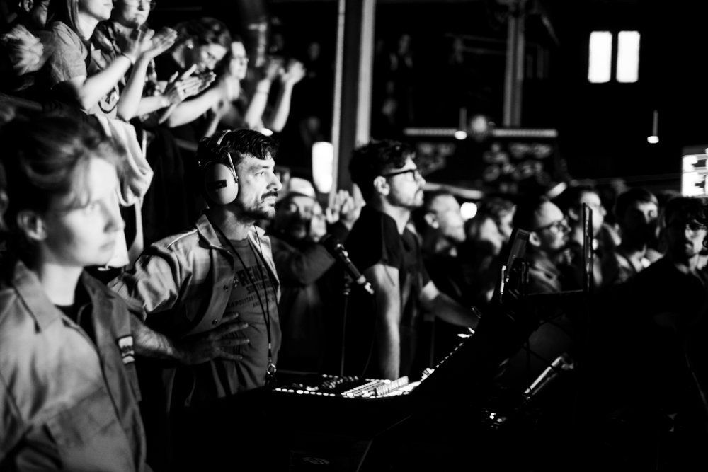 The crowd singing along, black and white
