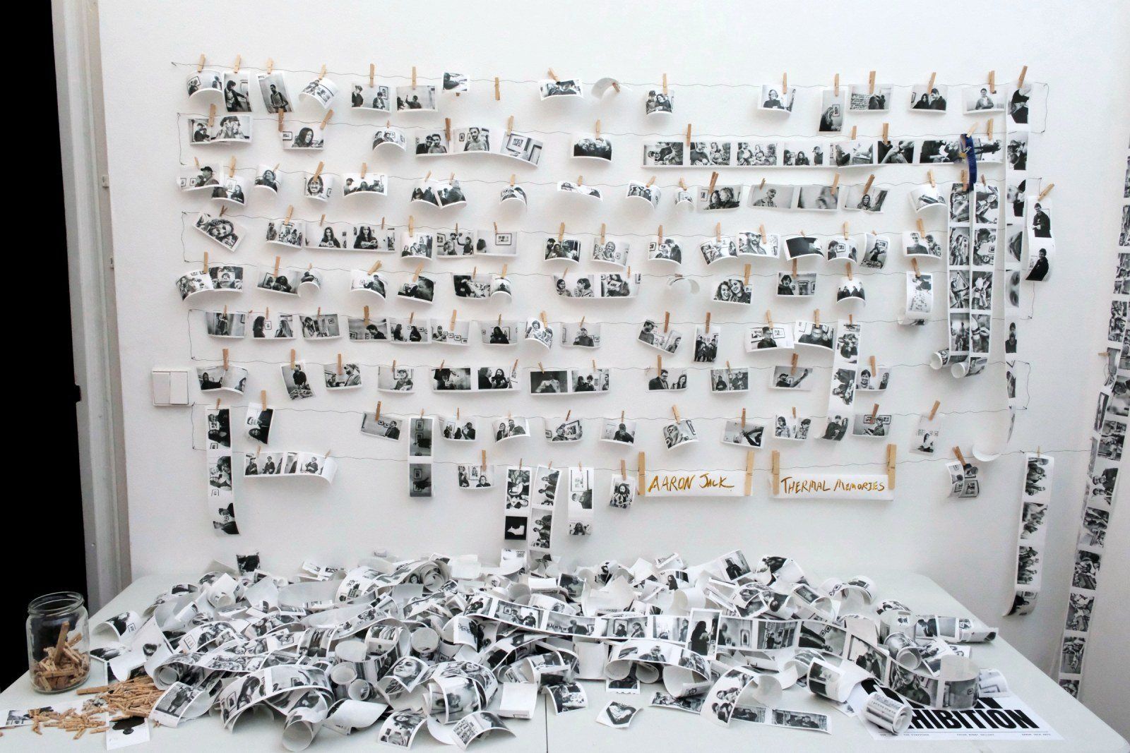 The full portrait wall above the table of strips