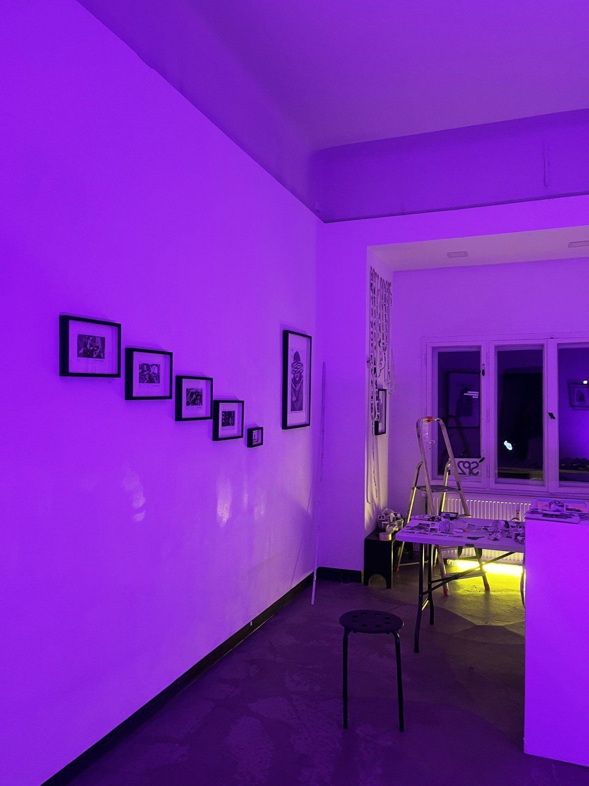 The gallery lit purple at night