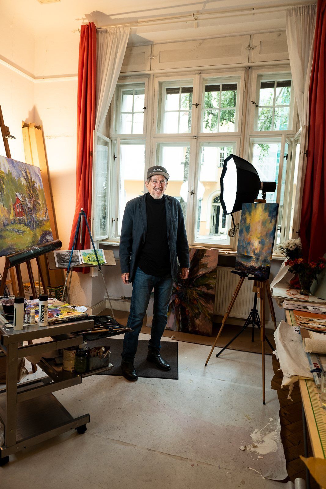 The whole studio from the doorway, easels and lights