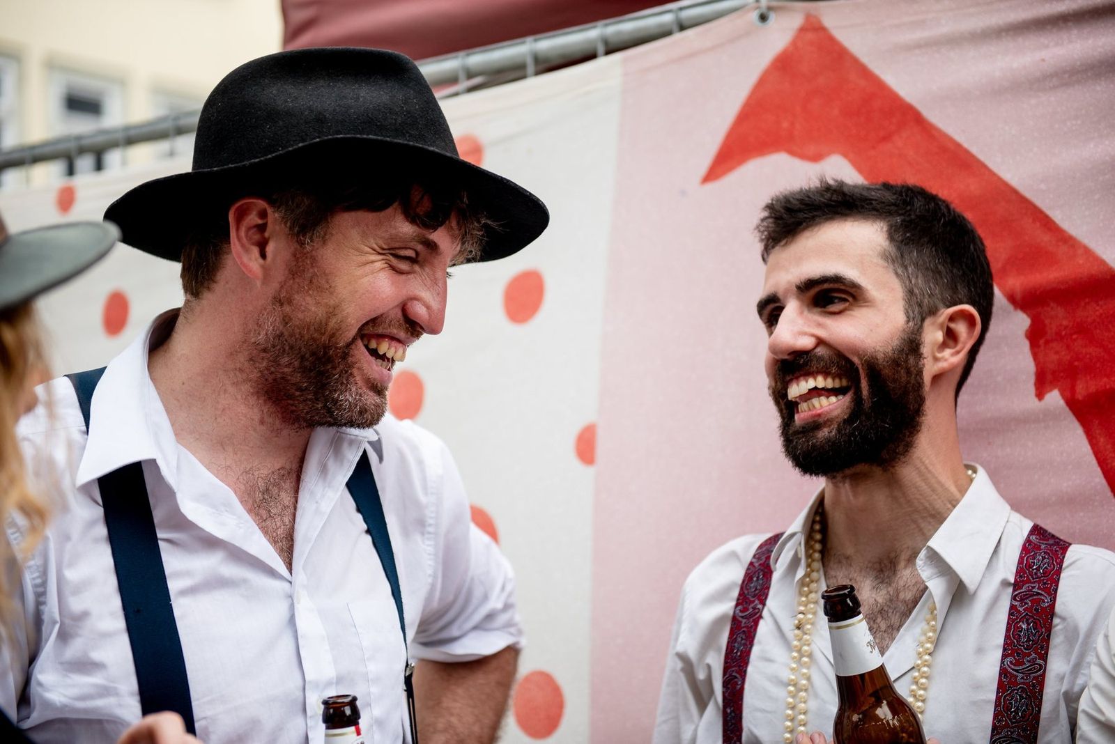Two band members laughing together after the show
