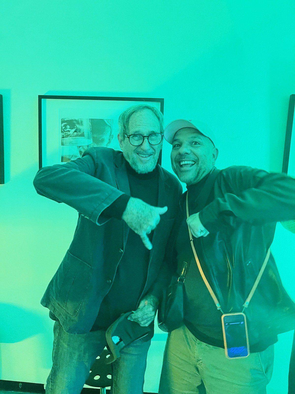 Two guests posing in green light