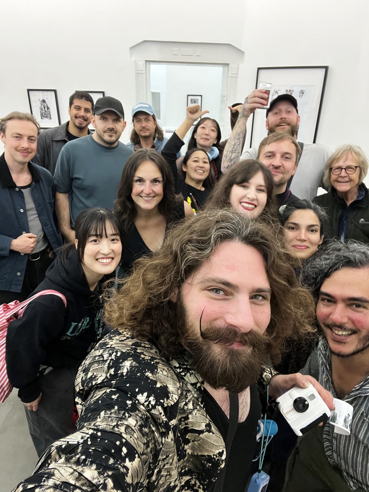 Visitors posing together at an exhibition opening