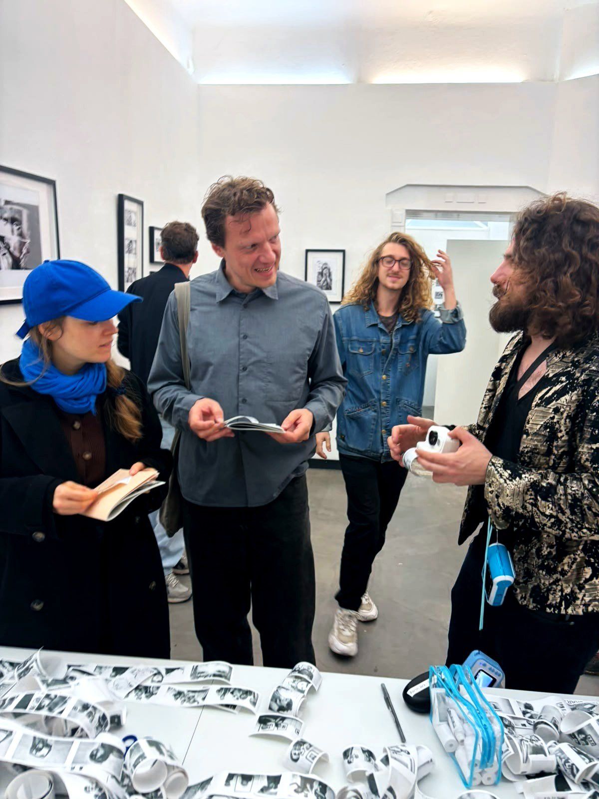 Visitors reading prints at the table