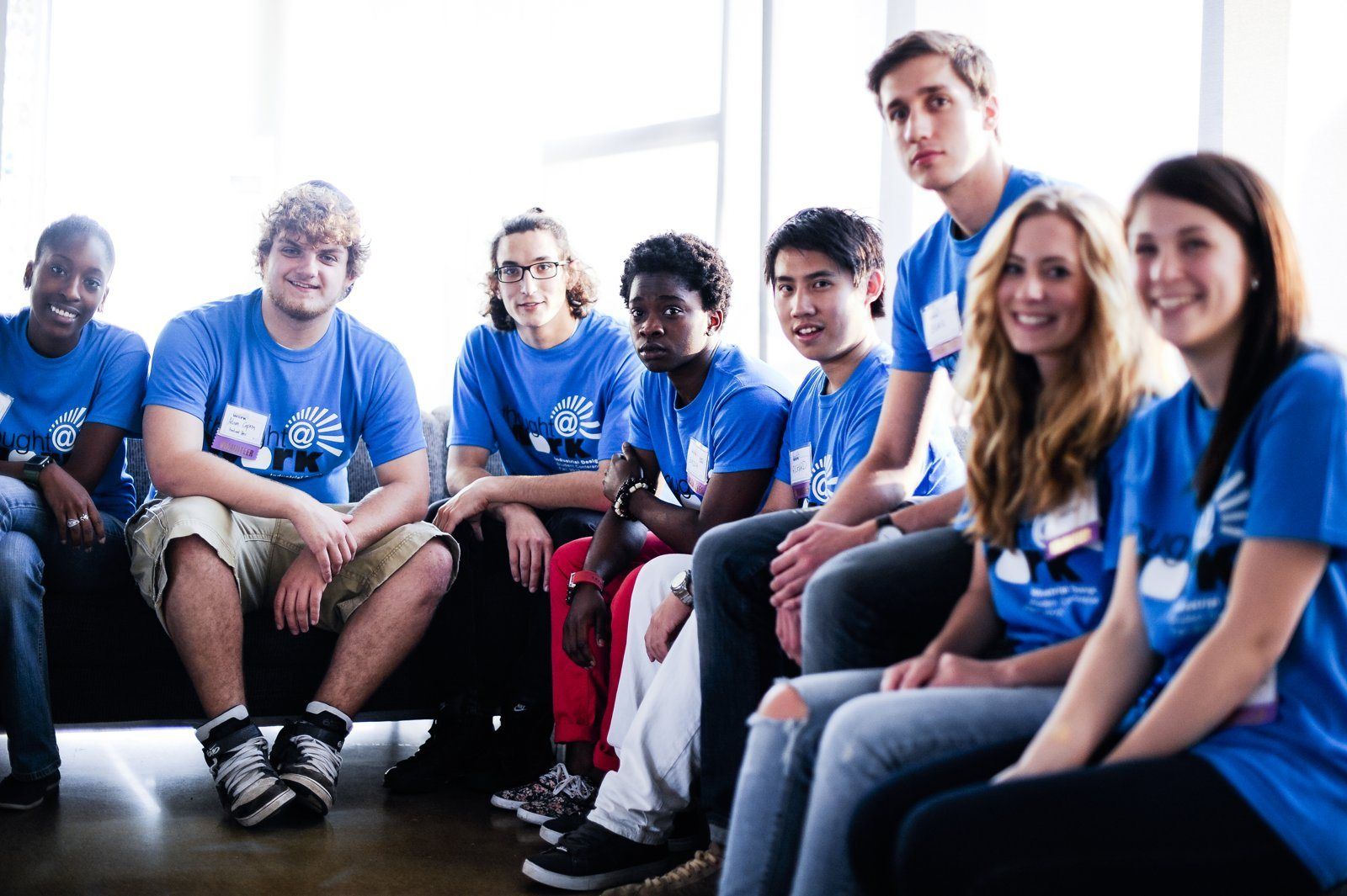 Volunteers in blue T-shirts on a sofa